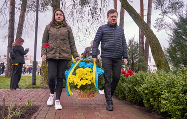 Yuriy Fomichev (right), the mayor of Slavutych, carries a bascket of flowers in the Ukrainian colours during the 36th anniversary of the Chernobyl nuclear disaster to the Chernobyl Memorial. Fomichev...