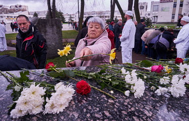 A woman places daffodils on the Chernobyl Memorial on the 36th anniversary of the Chernobyl disaster. The monument is dedicated to the firefighters and workers who went, ill-equipped, into the reactor...