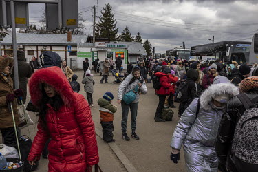 A crowd of several thousand or more, mainly women and children, queued up in the freezing cold at the Shehyni border crossing between Ukraine and Poland, waiting to cross into Europe on foot. Busses t...