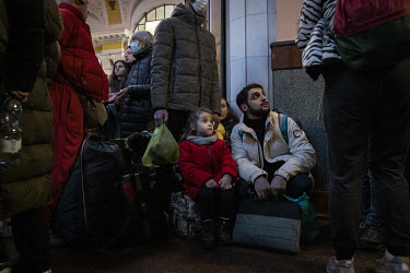 A young girl waits in a long queue for the evacuation trains bound for Poland.
