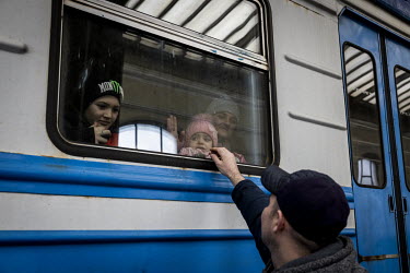 Dima Kurganov (39) says goodbye to his wife and two children before they wait for an evacuation train to depart to Poland.