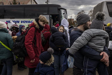 A crowd of several thousand or more, mainly women and children, queued up in the freezing cold at the Shehyni border crossing between Ukraine and Poland, waiting to cross into Europe on foot. Busses t...