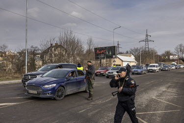 Security personnel stop vehicles at a checkpoint on the outskirts of Lviv.