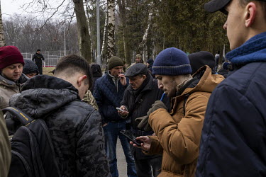 Ukrainian men between the ages of 18 and 60 sign up to join the territorial defences forces at a military school in Lviv.