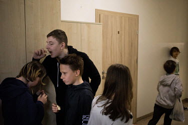Ukrainian pupils Ilya (13), Oleh (13) and Jarek (12) share a snack during a break between lessons at public primary school number 81 where around 10% of the school's pupils are from Ukraine, most of t...