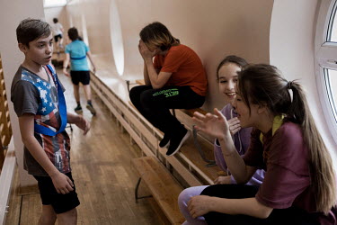 Ukrainian and Polish pupils socialise, with Ilya (13), from Kiev in red top, during a physical education lesson at public primary school number 81 where around 10% of the school's pupils are from Ukra...