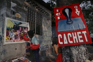 Artist Cheri Samba in 1986 on the roadside where he paints and makes billboards.