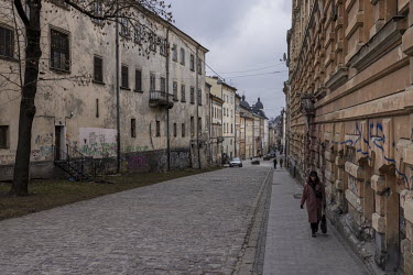 A woman walks along a street in downtown Lviv.