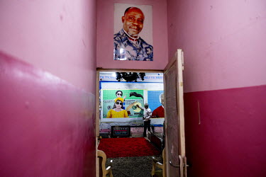 Congolese artist Cheri Samba painting at his house in Ndjili.