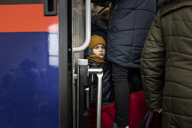 A child in the doorway of a packed carriage on a train bound for Poland from Lviv station.