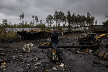 A man and his dog examine the burnt out remnants of as many as nine Russian tanks and armoured fighting vehicles litter a forested road leading out of the town of Dmytrivka. Ukrainian soldiers said th...