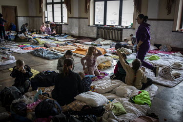 Women and children, many of them from the besieged city of Kharkiv, rest in a waiting hall at Lviv train station.