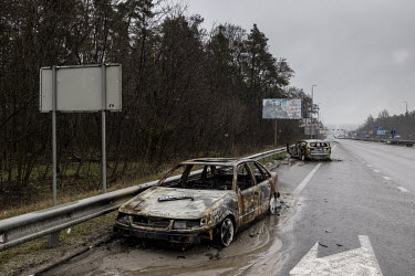 The burnt out remains of numerous civilian cars, many with the visible marks cause by bullets and shrapnel, are dotted along the main highway on the west of Kyiv.