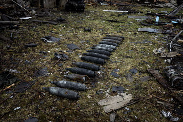 Unexploded munitions in a garden next to the scene of a destroyed Russian convoy.