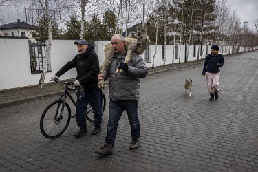 A man carries a pet deer that had escaped from its owner's house during clashes in a gated community on the outskirts of Kyiv last week before Russian forces pulled back from the area.
