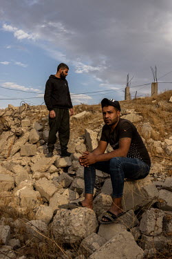 Abdul Aziz Ahmed Araj, right, and his brother Saddam amid the ruins of the warehouse where their brother and other family members were killed in the Yabisat neighbourhood of West Mosul. On 5 March, 20...