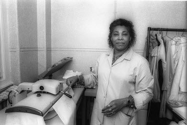A woman ironing uniforms.