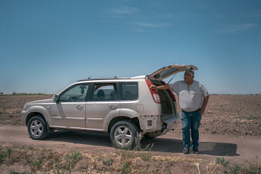 Jose Maria Osorio Alatorre, chairman of the Production Societies of Southern Sonora (USPRUSS), stands beside his vehicle while he overseas the harvesting of his wheat fields. The local farmer family's...