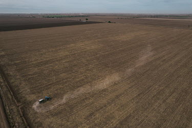 Jorge Alberto Ruiz (30) drives a tractor and spreads urea, a nitrogenous compound fertiliser, across a dry field where wheat will be planted. Around October, when the land is dry, many local farmers a...
