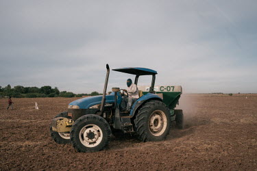 Jorge Alberto Ruiz (30) drives a tractor and spreads urea, a nitrogenous compound fertiliser, across a dry field where wheat will be planted. Around October, when the land is dry, many local farmers a...