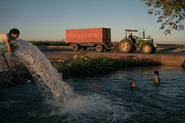 Locals from around the valley take a dip in an artificial pond filled with irrigation water supplied by dams and wells. 267 miles of agricultural drains eventually discharge into the sea of Cortez, pr...