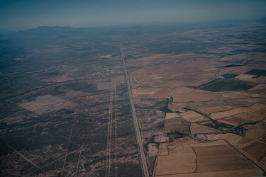 Wheat fields bordering a highway in the Yaqui Valley. The Yaqui Valley is a wheat-producing region in northwestern Mexico constituted by family farmers that supplies the national market and bigger pro...