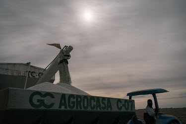 Jorge Alberto Ruiz (30) observes how urea granules fall from a local agro-industrial economic consortium's truck into a fertiliser spreader in a dry field where wheat will be planted. Around October,...