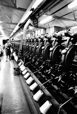 A worker preparing yarn for weaving at the Trawden textile mill.