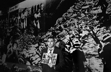 A man with pictures of his murdered family at the 50th commemoration of the mass execution of the city's Jewish population by the occupying Nazis at the Babi Yar ravine in Kiev in 1941. This was the f...