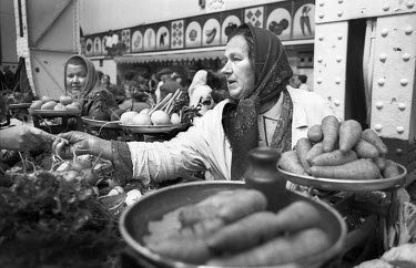 A woman in a market selling vegetables produced on a private farm. In the run up to independence the Soviet collective farming system collapsed which, when combined with runaway inflation, caused seve...