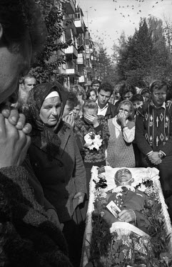 The funeral cortege of a young man, killed while riding a motorbike, outside his apartment before a procession on foot to the Ukrainian Catholic church on the outskirts of Lviv. During Soviet times Uk...