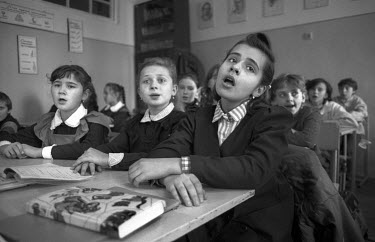 Pupils singing the national anthem in School 62 in Lviv, the city at heartland of Ukrainian nationalism. This, together with any other Ukrainian music, was banned under the Soviet system. Having aband...