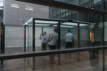 Employees are smoking cigarettes in a smoker's sealed zone in the World Trade Center in Zuidas.