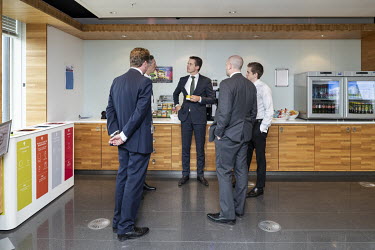 Staff socialise over coffee in a breakout area at Aegon's headquarters.