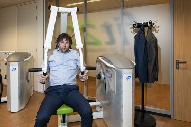 An employee working out in a suit during his lunch break at the headquarters of PricewaterhouseCoopers (PwC).