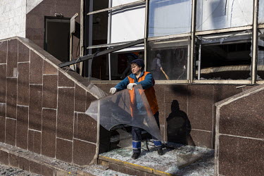 A worker clears the site of a Russian missile strike that damaged the Lukyanivska metro station.