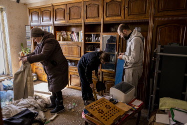 Kateryna Pomomarenko, her son Sergei and daughter-in-law Yana, work to clean up the destruction in Kateryna's apartment. Part of a Russian missile, intercepted by Ukrainian air defences, hit her build...