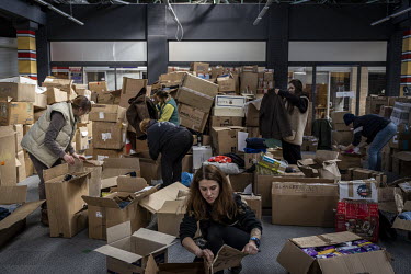 Volunteers work to sort aid donations at depot in Kyiv.