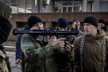 Territorial Defence Volunteers learn how to use a rocket launcher and other weapons before being deployed to fight against Russian forces near Kyiv.