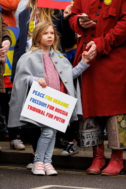 A girl holds a sign that reads: 'Peace for Ukraine, Freedom from Russia, Tribunal for Putin' during a solidarity protest in Whitehall against the Russian invasion of Ukraine. The protest brought toget...