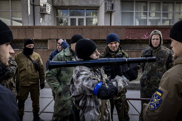 Territorial Defence Volunteers learn how to use a rocket launcher and other weapons before being deployed to fight against Russian forces near Kyiv.
