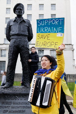 A woman, standing beside the statue of Field Marshal Montgomery, holds a sign that reads: 'Support Ukraine, Save Europe!' during a solidarity protest in Whitehall against the Russian invasion of Ukrai...