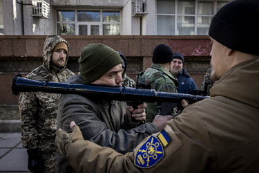 Territorial Defence Volunteers, including a young Californian man named Tony (green hat), learn how to use a rocket launcher and other weapons before being deployed to fight against Russian forces nea...