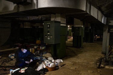 Economics student, Vitalii Smahluk (20), works on his laptop in the underground bunker where he has been living since the start of the Russian invasion of Ukraine.