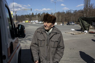 An elderly man is one of a steady stream of civilians who arrived in minivans and ambulances, some injured, at an aid station in north west Kyiv, having being evacuated from the besieged town of Irpin...