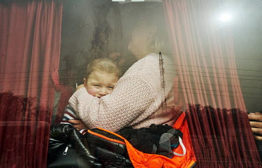 A mother with her child in a minibus. About five minibuses with evacuees arrived to the relative safety of Zaporozhia from the Russian-occupied city of Berdyansk.
