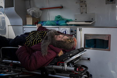 A sick woman lies in the back of an ambulance as a steady stream of civilians arrived in minivans and ambulances at an aid station in north west Kyiv, having being evacuated from the besieged town of...