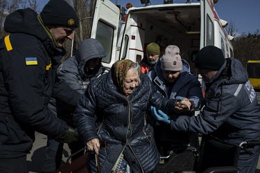 A sick woman is helped from an ambulance as a steady stream of civilians arrived in minivans and ambulances at an aid station in north west Kyiv, having being evacuated from the besieged town of Irpin...