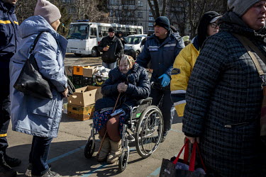 A sick woman sits in a wheelchair as a steady stream of civilians arrived in minivans and ambulances at an aid station in north west Kyiv, having being evacuated from the besieged town of Irpin. They...