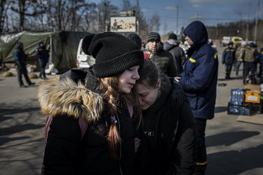 A woman and child embrace as a steady stream of civilians arrived in minivans and ambulances at an aid station in north west Kyiv, having being evacuated from the besieged town of Irpin. They were car...